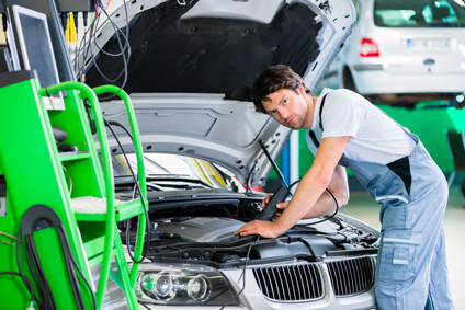 BMP Autoservice technician working on a BMW engine issue